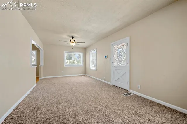an empty room with windows and closet