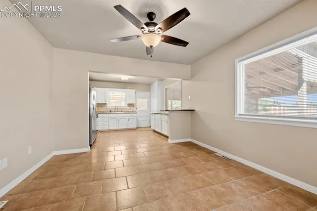 a view of an empty room with a kitchen