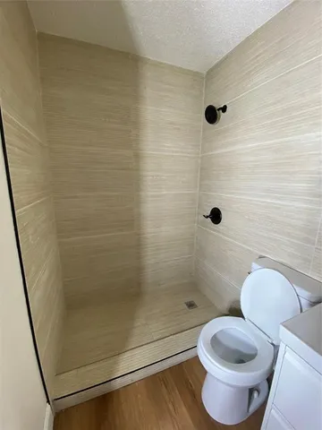 a bathroom with a toilet and a shower
