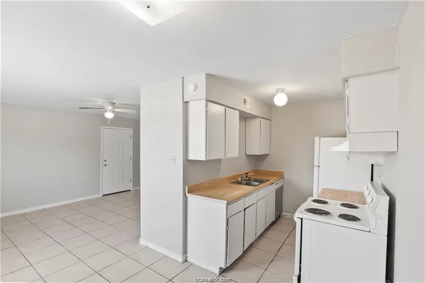 a kitchen that has a sink and a stove