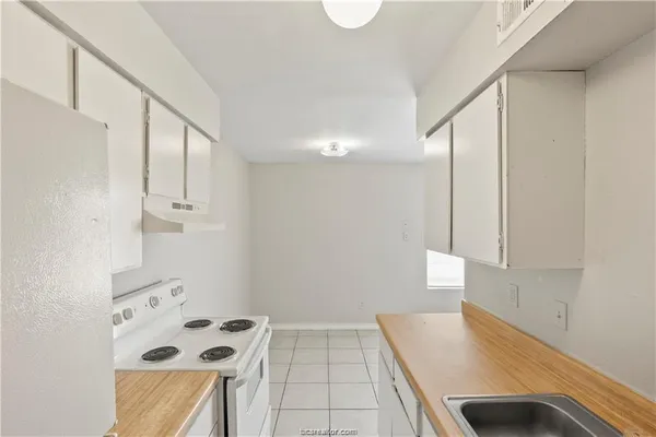 a room with window and cabinets