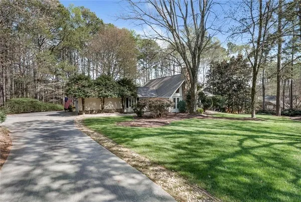 a front view of a house with yard and green space