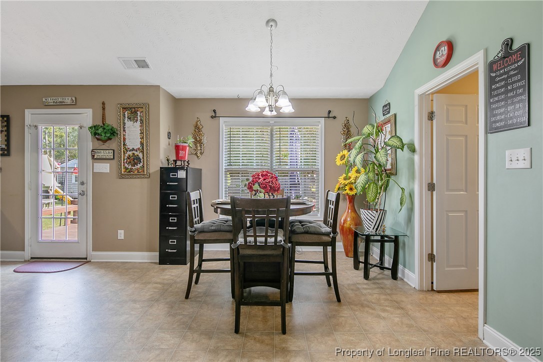 245 Apple Tree Circle Raeford, NC 28376 - Photo 11 of 41 a dining room with furniture and window