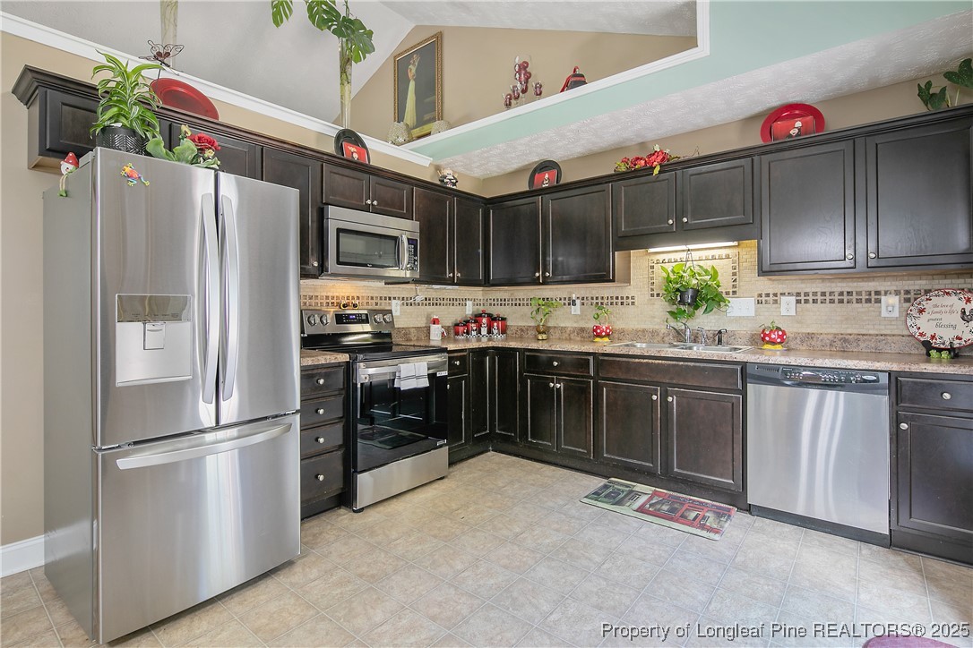 245 Apple Tree Circle Raeford, NC 28376 - Photo 16 of 41 a kitchen with stainless steel appliances a refrigerator sink and cabinets