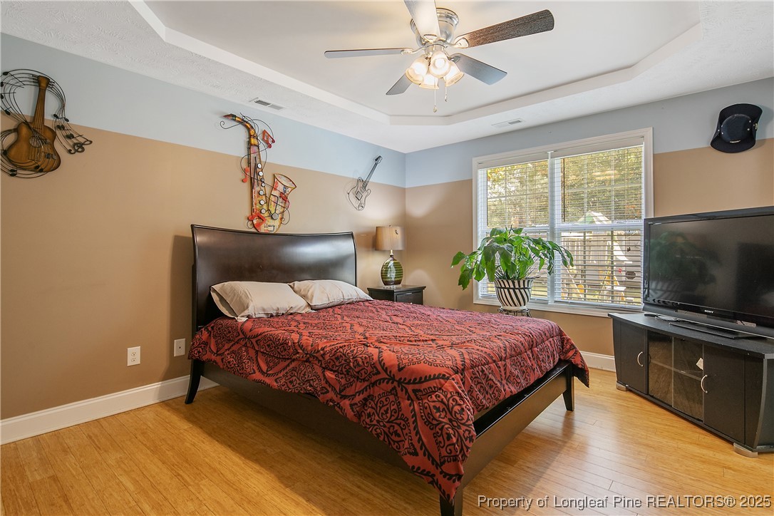 245 Apple Tree Circle Raeford, NC 28376 - Photo 19 of 41 a bedroom with a bed and a flat screen tv