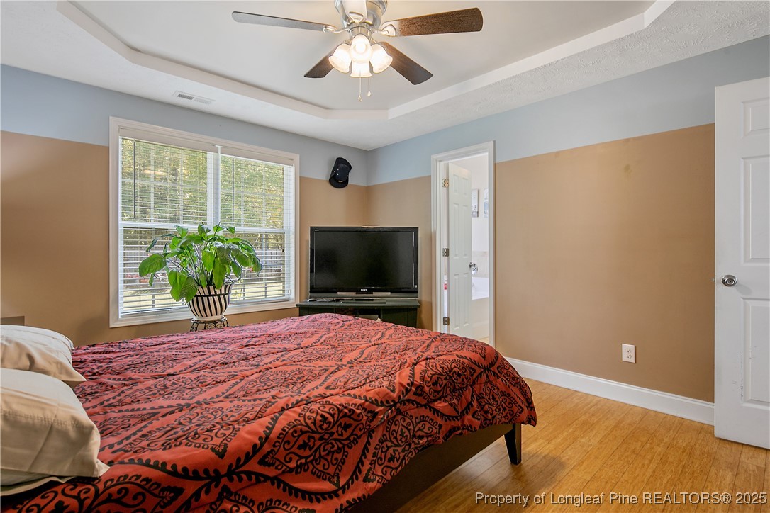 245 Apple Tree Circle Raeford, NC 28376 - Photo 20 of 41 a bedroom with a bed and a flat screen tv