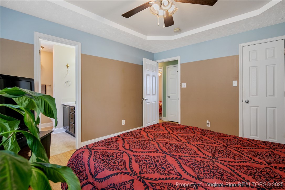 245 Apple Tree Circle Raeford, NC 28376 - Photo 21 of 41 a bedroom with a large bed and a potted plant
