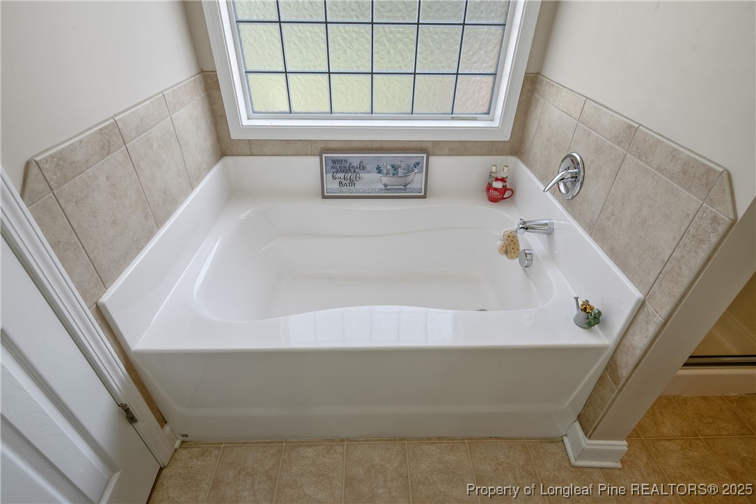 245 Apple Tree Circle Raeford, NC 28376 - Photo 24 of 41 a bath tub sitting in a bathroom next to a window