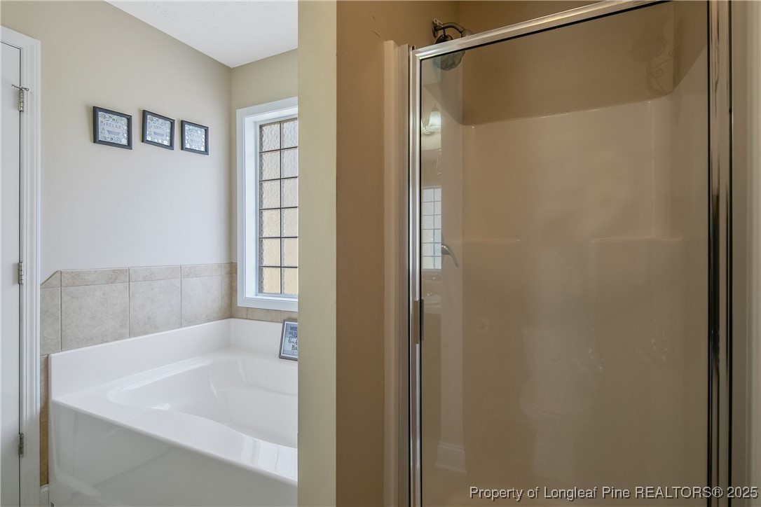 245 Apple Tree Circle Raeford, NC 28376 - Photo 25 of 41 a bathroom with a bathtub and a shower