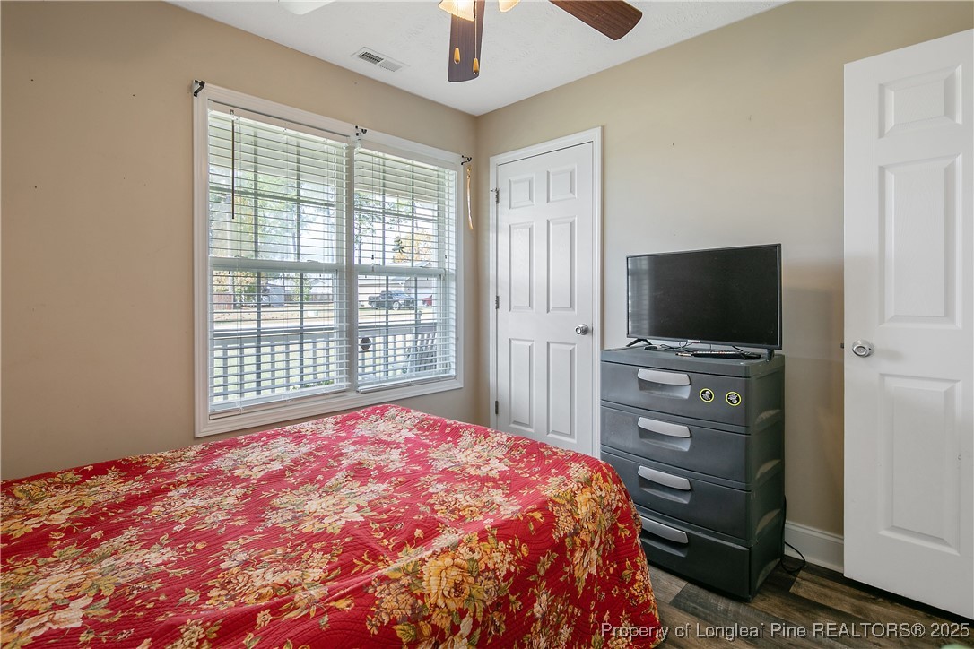 245 Apple Tree Circle Raeford, NC 28376 - Photo 26 of 41 a bedroom with a bed and a flat screen tv