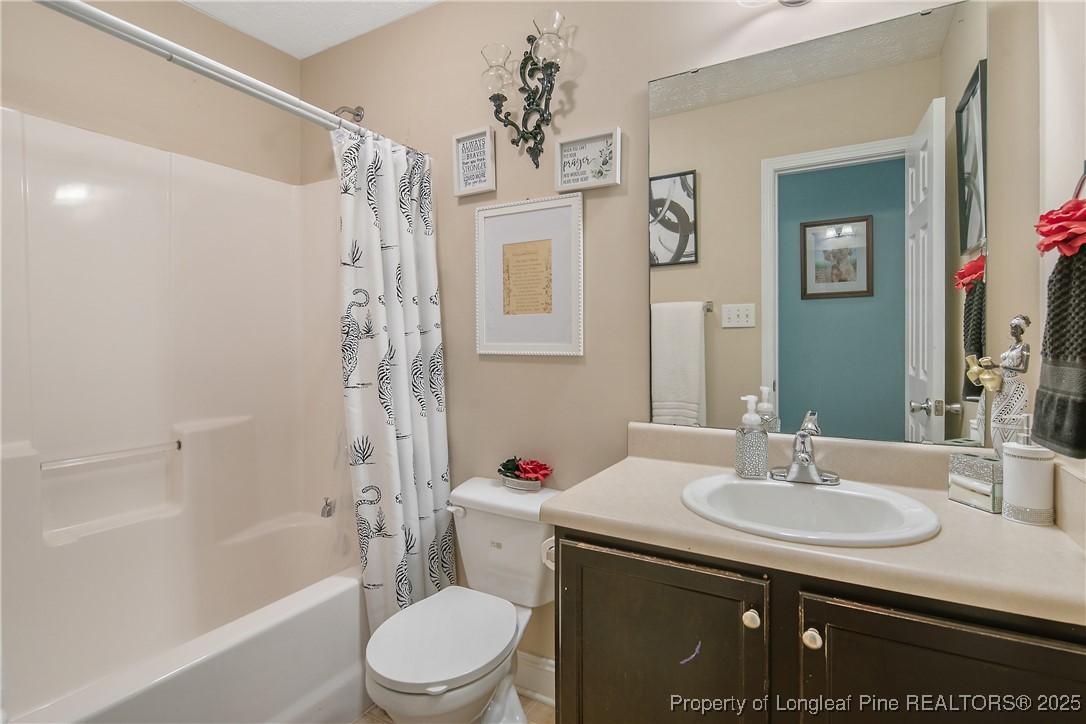 245 Apple Tree Circle Raeford, NC 28376 - Photo 28 of 41 a bathroom with a granite countertop sink toilet and shower