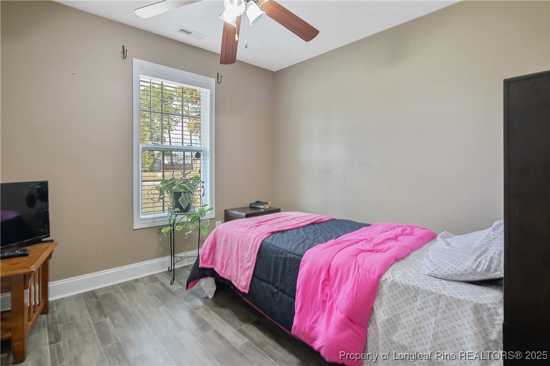 245 Apple Tree Circle Raeford, NC 28376 - Photo 29 of 41 a bedroom with a bed and a flat screen tv