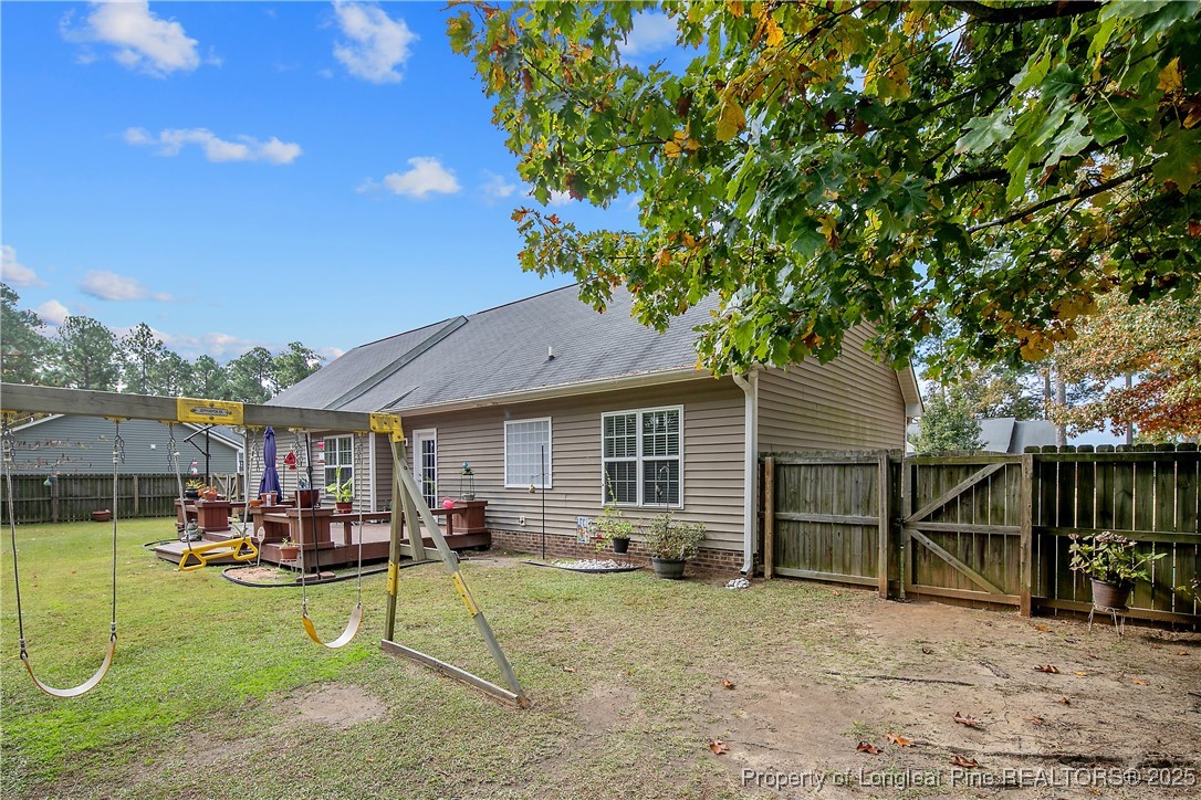 245 Apple Tree Circle Raeford, NC 28376 - Photo 33 of 41 a view of a backyard with table and chairs and potted plants