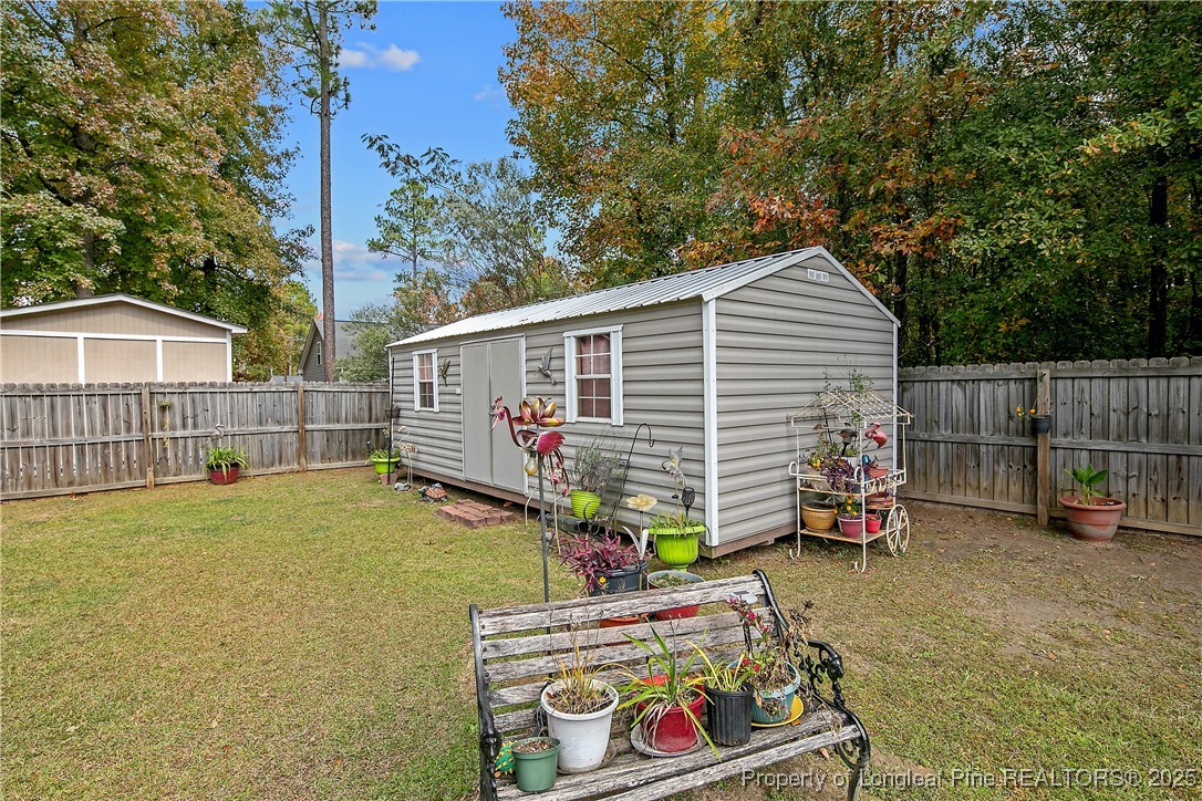 245 Apple Tree Circle Raeford, NC 28376 - Photo 36 of 41 a view of backyard with cabin and seating