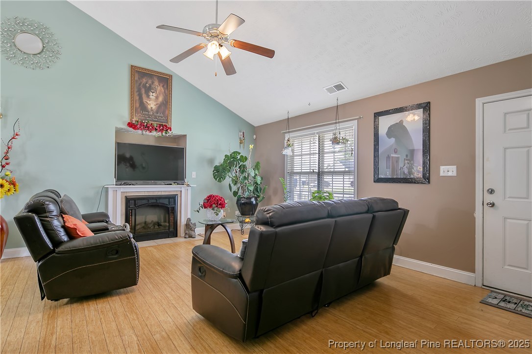 245 Apple Tree Circle Raeford, NC 28376 - Photo 8 of 41 a living room with furniture and a fireplace