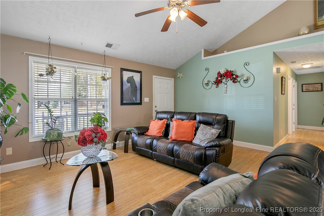 245 Apple Tree Circle Raeford, NC 28376 - Photo 9 of 41 a living room with furniture and flowers