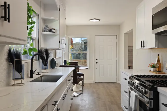 a kitchen that has a sink and a stove