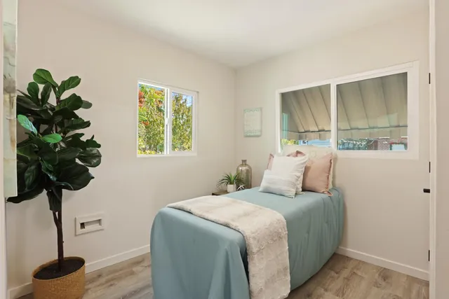 a bedroom with bed and a window