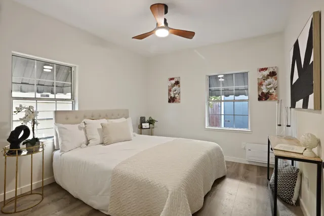 a bedroom with a bed and a chandelier