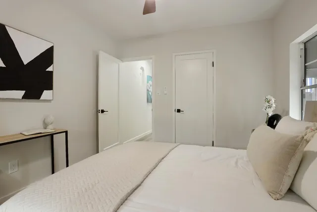 a bedroom with a bed and a flat screen tv