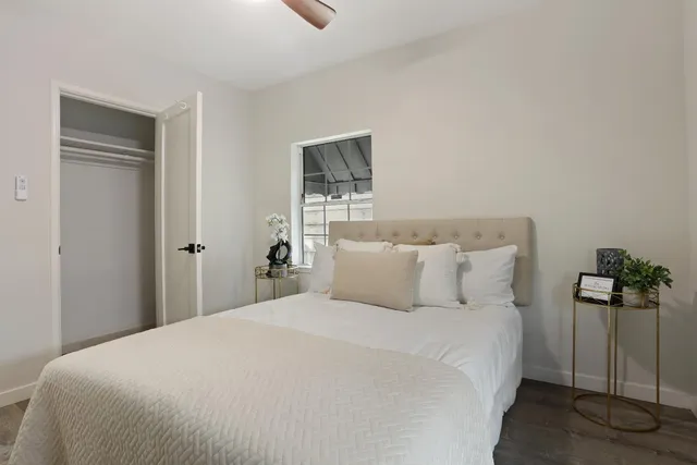 a bedroom with a bed and a potted plant