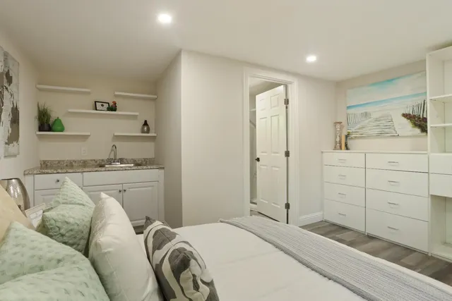 a bedroom with a bad and dresser