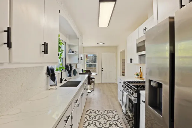 a kitchen with sink refrigerator and stove