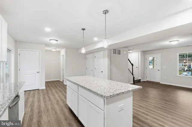 a view of an empty room and wooden floor