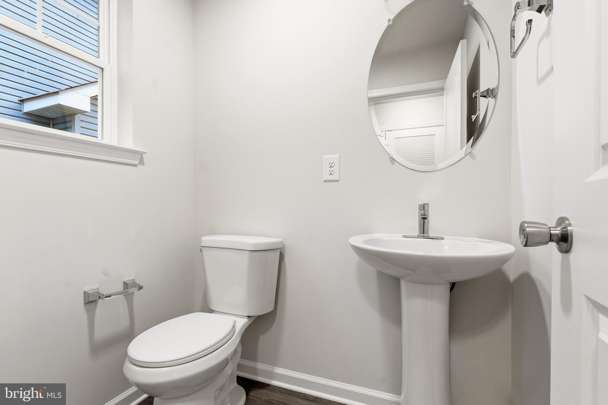 105 West Washington Avenue Magnolia, NJ 08049 - Photo 14 of 28 a bathroom with a toilet a sink and mirror