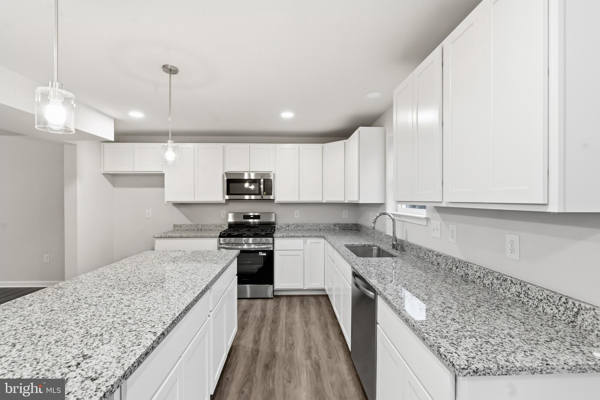 105 West Washington Avenue Magnolia, NJ 08049 - Photo 14 of 31 a kitchen with stainless steel appliances granite countertop a sink stove and refrigerator