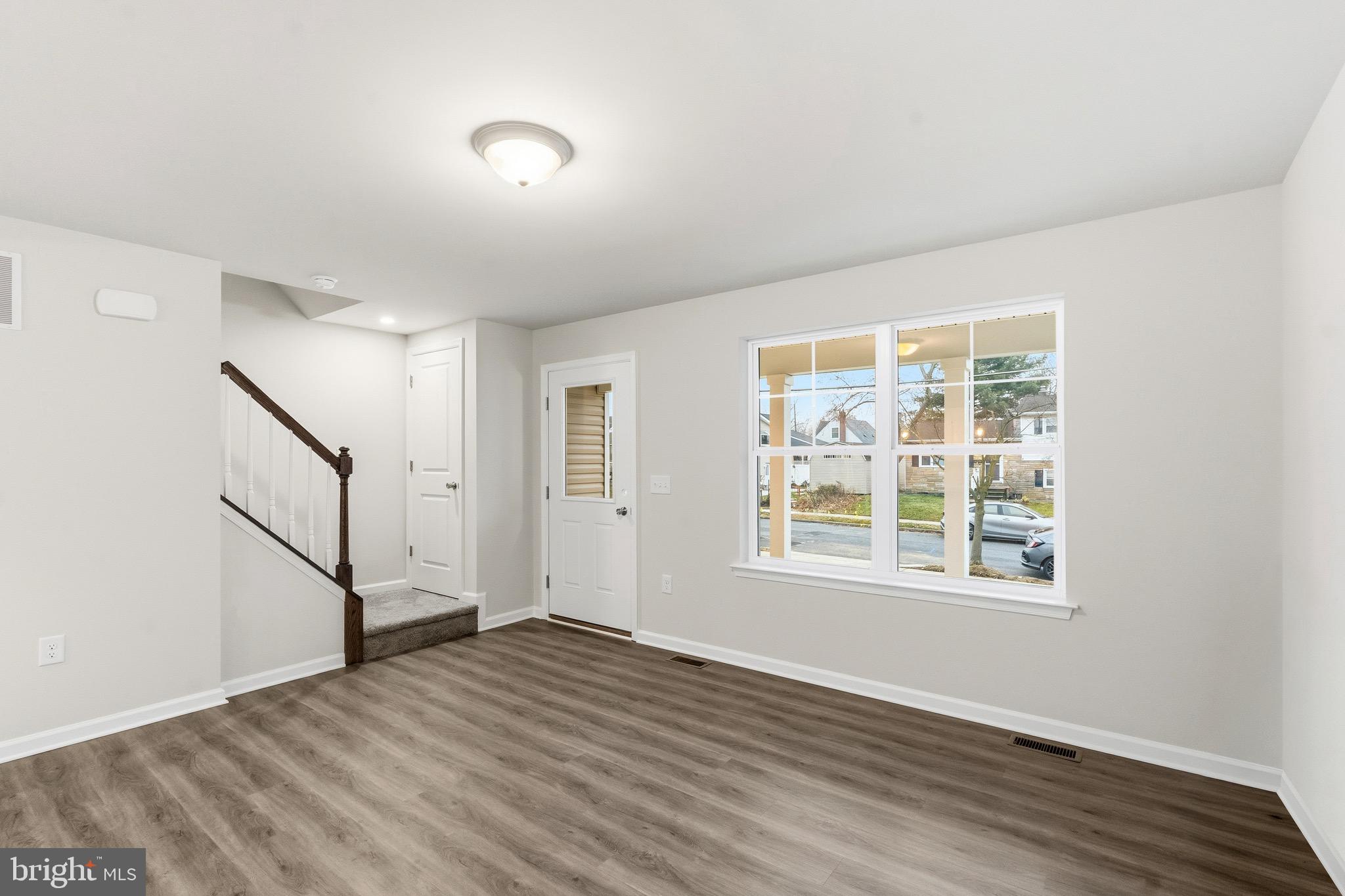 105 West Washington Avenue Magnolia, NJ 08049 - Photo 18 of 31 an empty room with wooden floor and windows