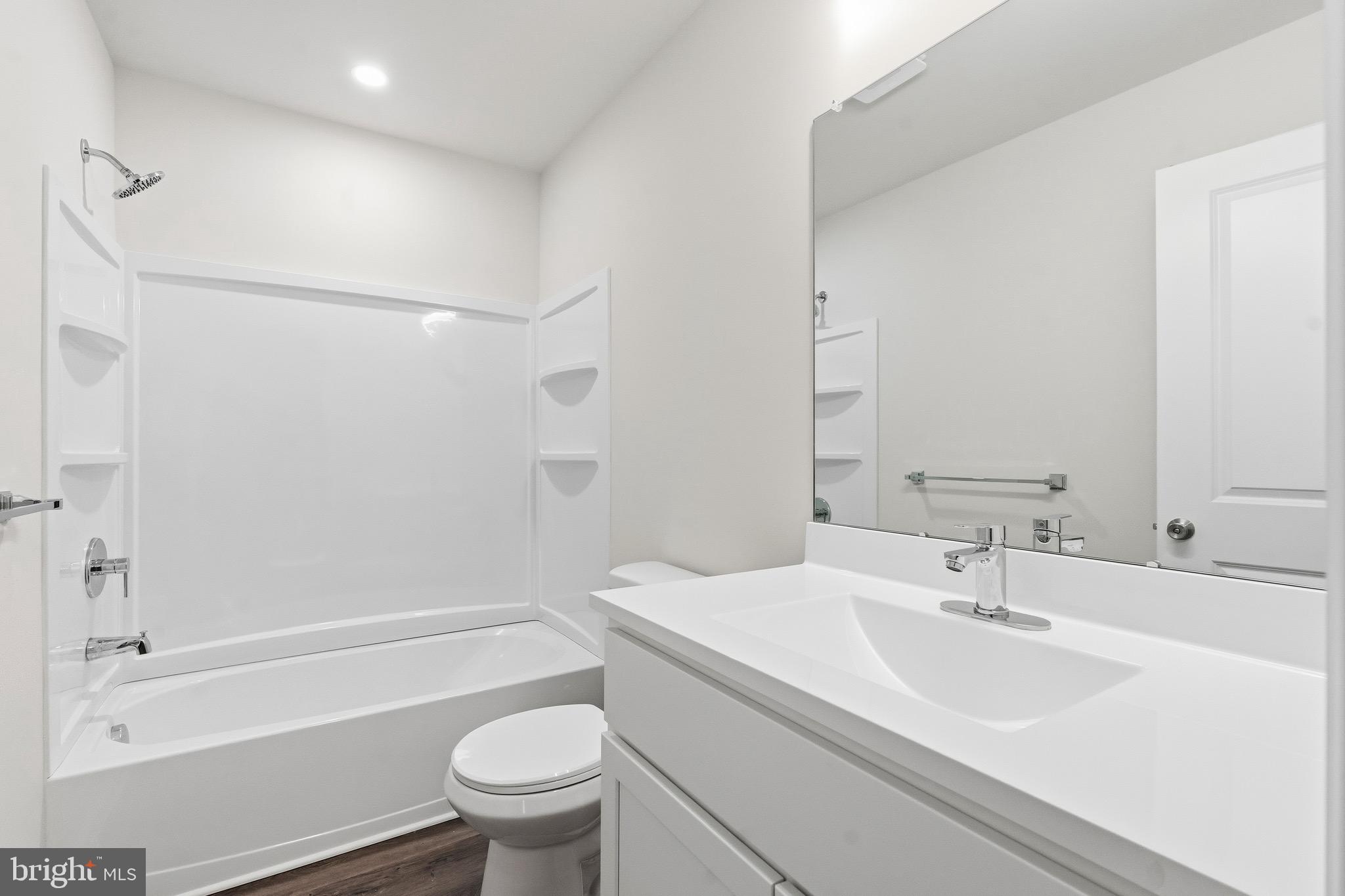 105 West Washington Avenue Magnolia, NJ 08049 - Photo 24 of 28 a bathroom with a sink a toilet and a large mirror