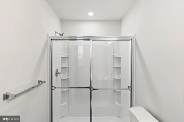 a bathroom with a shower and a glass door