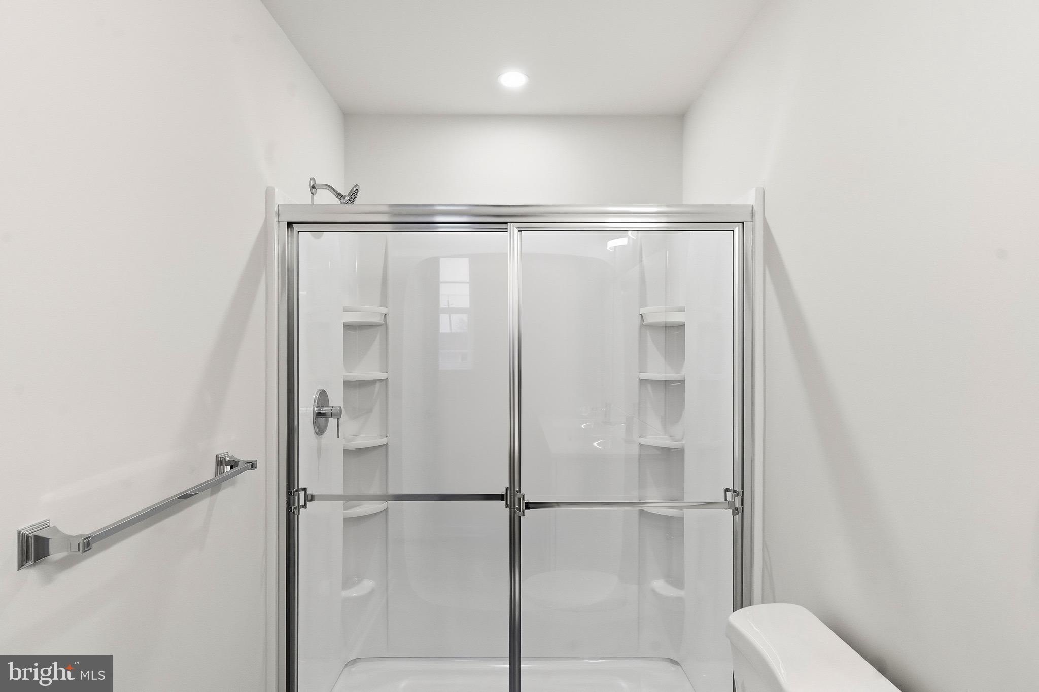 105 West Washington Avenue Magnolia, NJ 08049 - Photo 24 of 31 a bathroom with a shower and a glass door