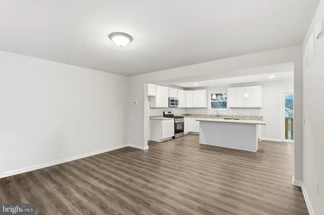 a view of kitchen with wooden floor and electronic appliances