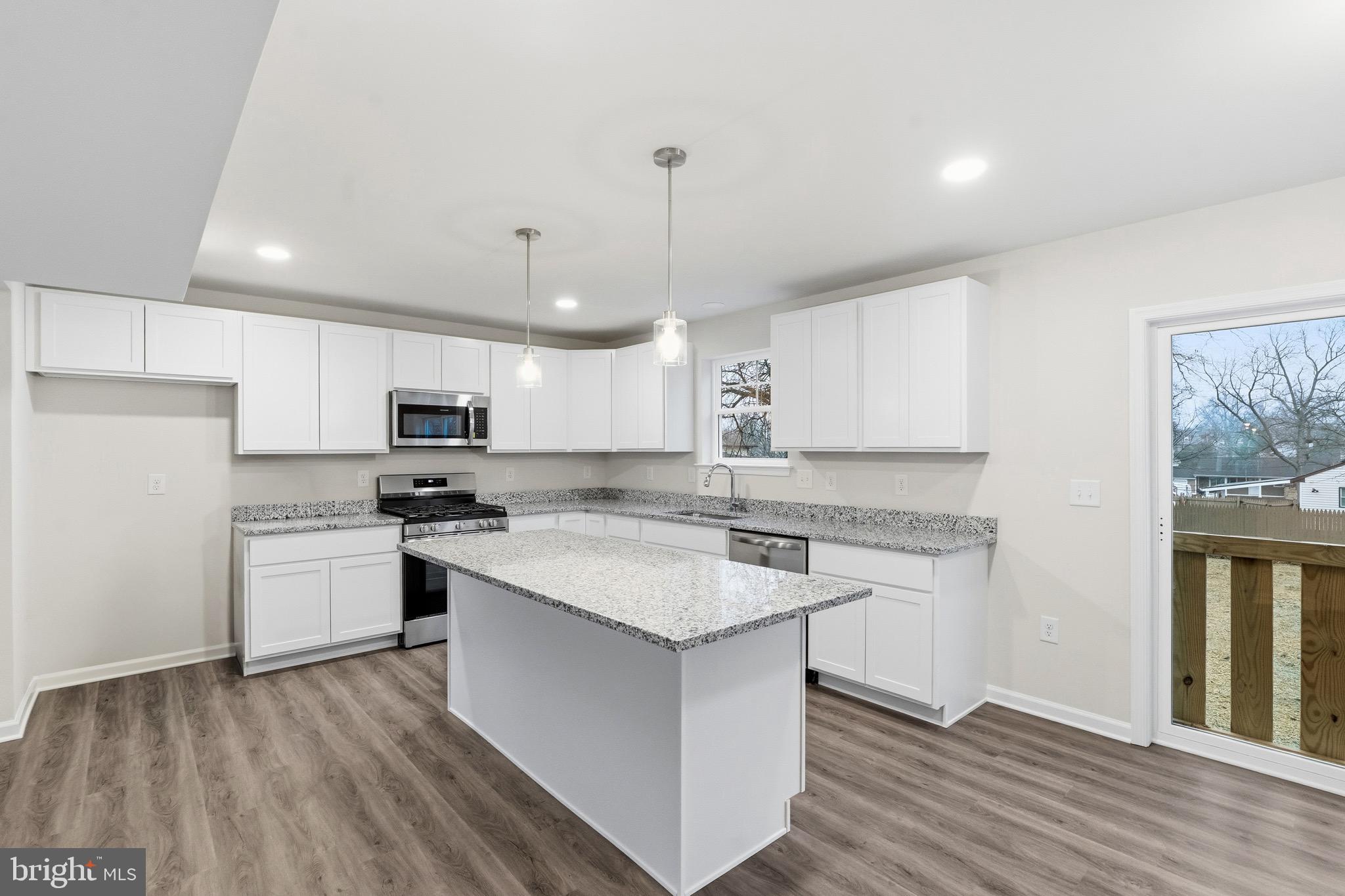 105 West Washington Avenue Magnolia, NJ 08049 - Photo 6 of 28 a kitchen with a stove a sink and a refrigerator