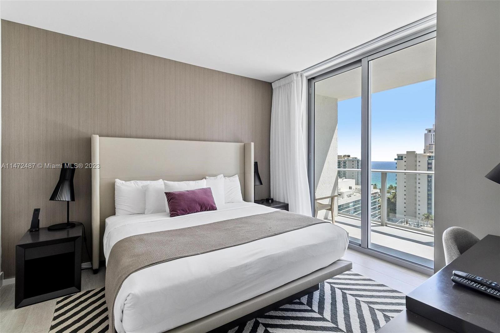 4010 South Ocean Drive, Unit R1107 Hollywood, FL 33019 - Photo 12 of 25 a bedroom with a bed and wooden floor