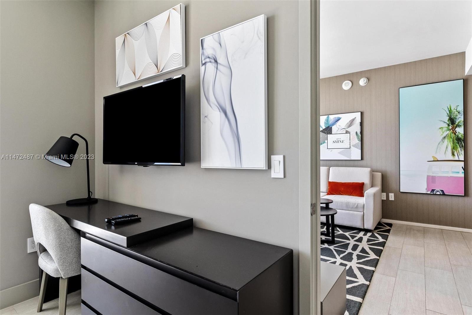 4010 South Ocean Drive, Unit R1107 Hollywood, FL 33019 - Photo 15 of 25 a kitchen with stainless steel appliances a stove a microwave and wood cabinets