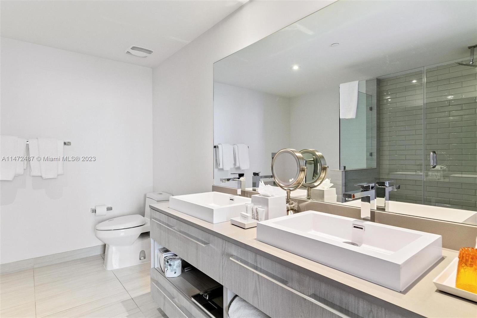 4010 South Ocean Drive, Unit R1107 Hollywood, FL 33019 - Photo 16 of 25 a bathroom with a sink mirror and toilet