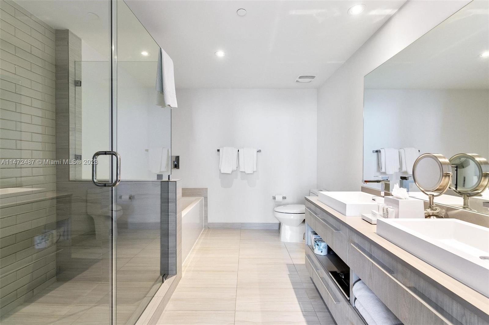 4010 South Ocean Drive, Unit R1107 Hollywood, FL 33019 - Photo 17 of 25 a bathroom with a double vanity sink mirror and shower