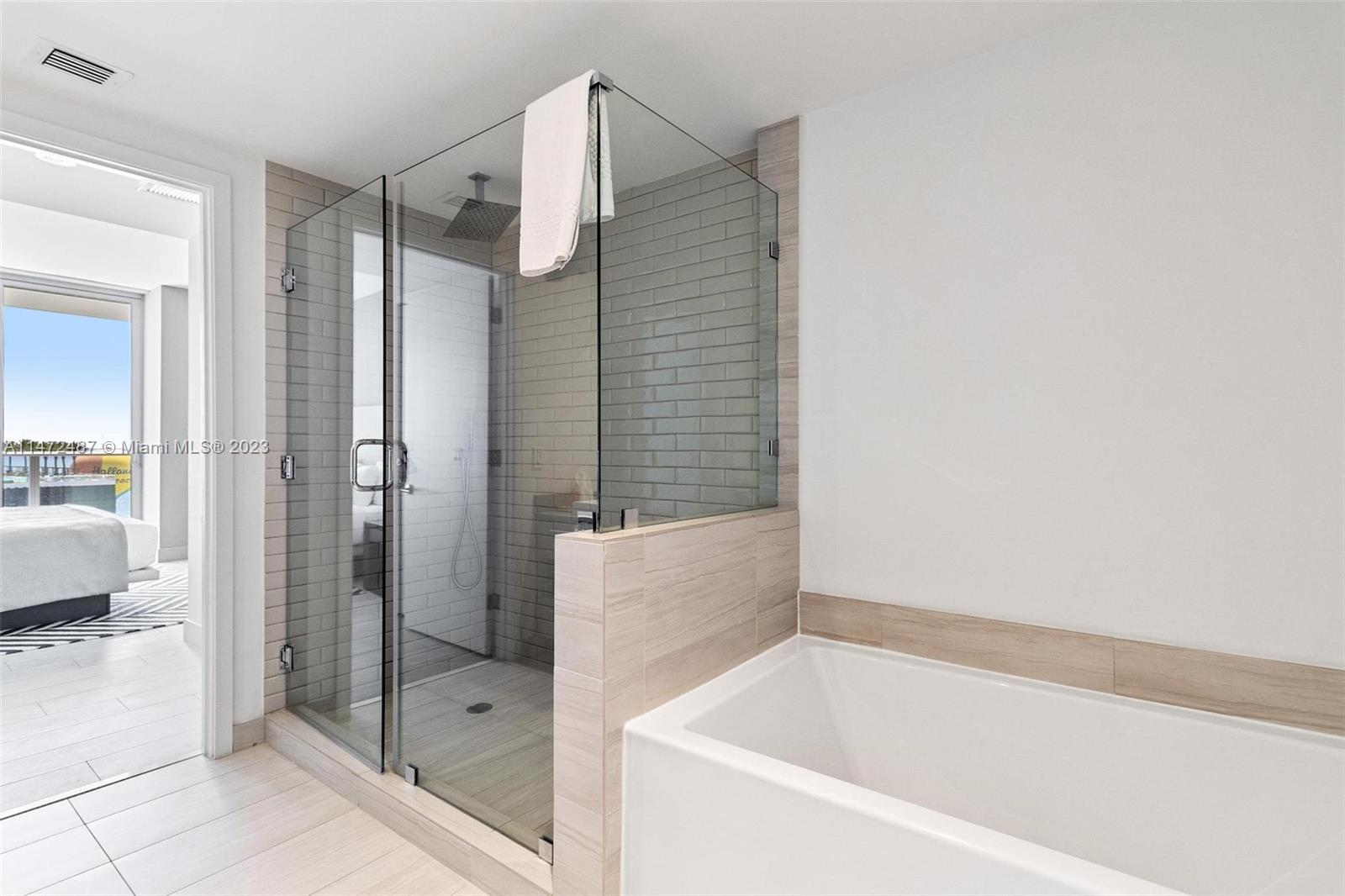 4010 South Ocean Drive, Unit R1107 Hollywood, FL 33019 - Photo 18 of 25 a bathroom with a bathtub and a shower