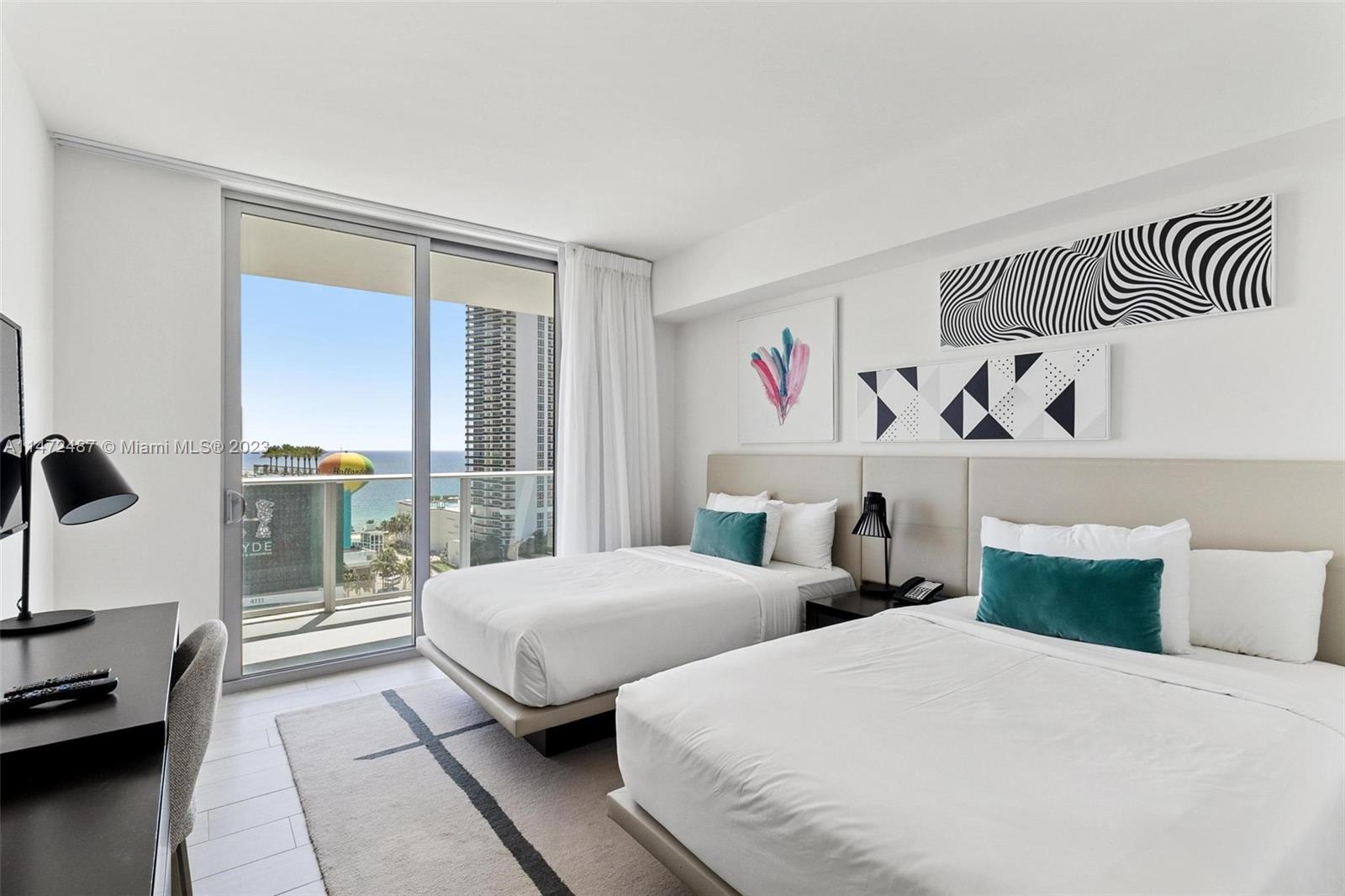 4010 South Ocean Drive, Unit R1107 Hollywood, FL 33019 - Photo 20 of 25 a bedroom with two beds and a large window