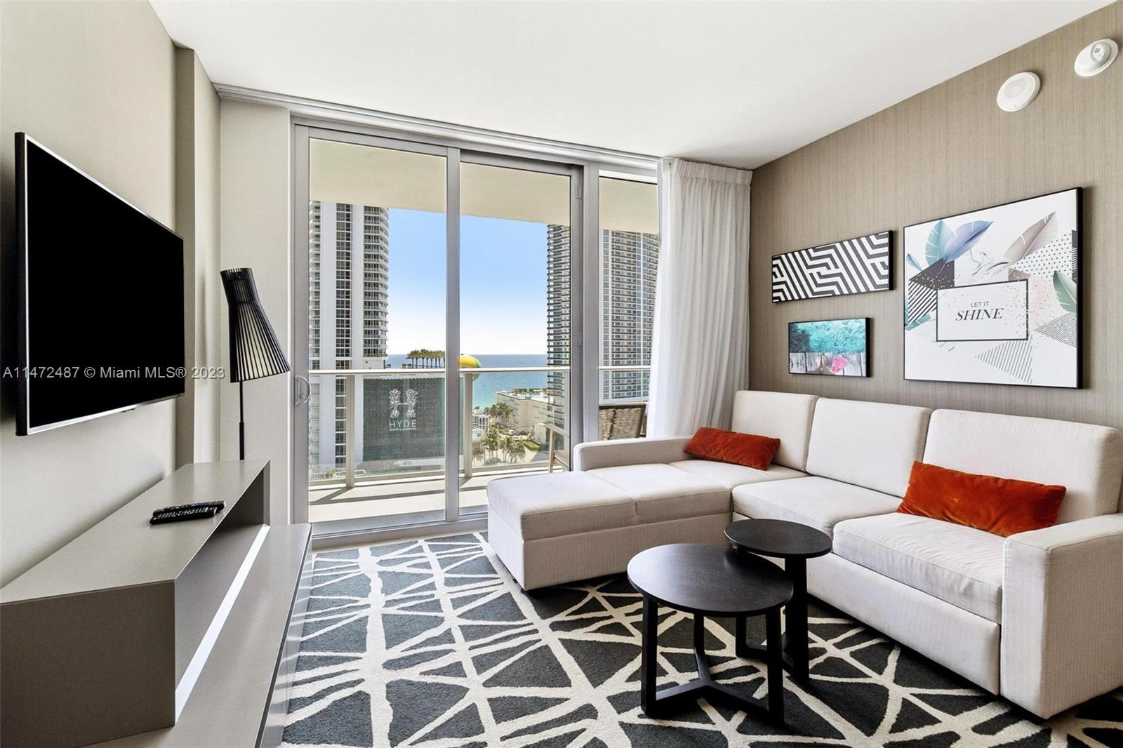 4010 South Ocean Drive, Unit R1107 Hollywood, FL 33019 - Photo 2 of 25 a living room with furniture and a flat screen tv
