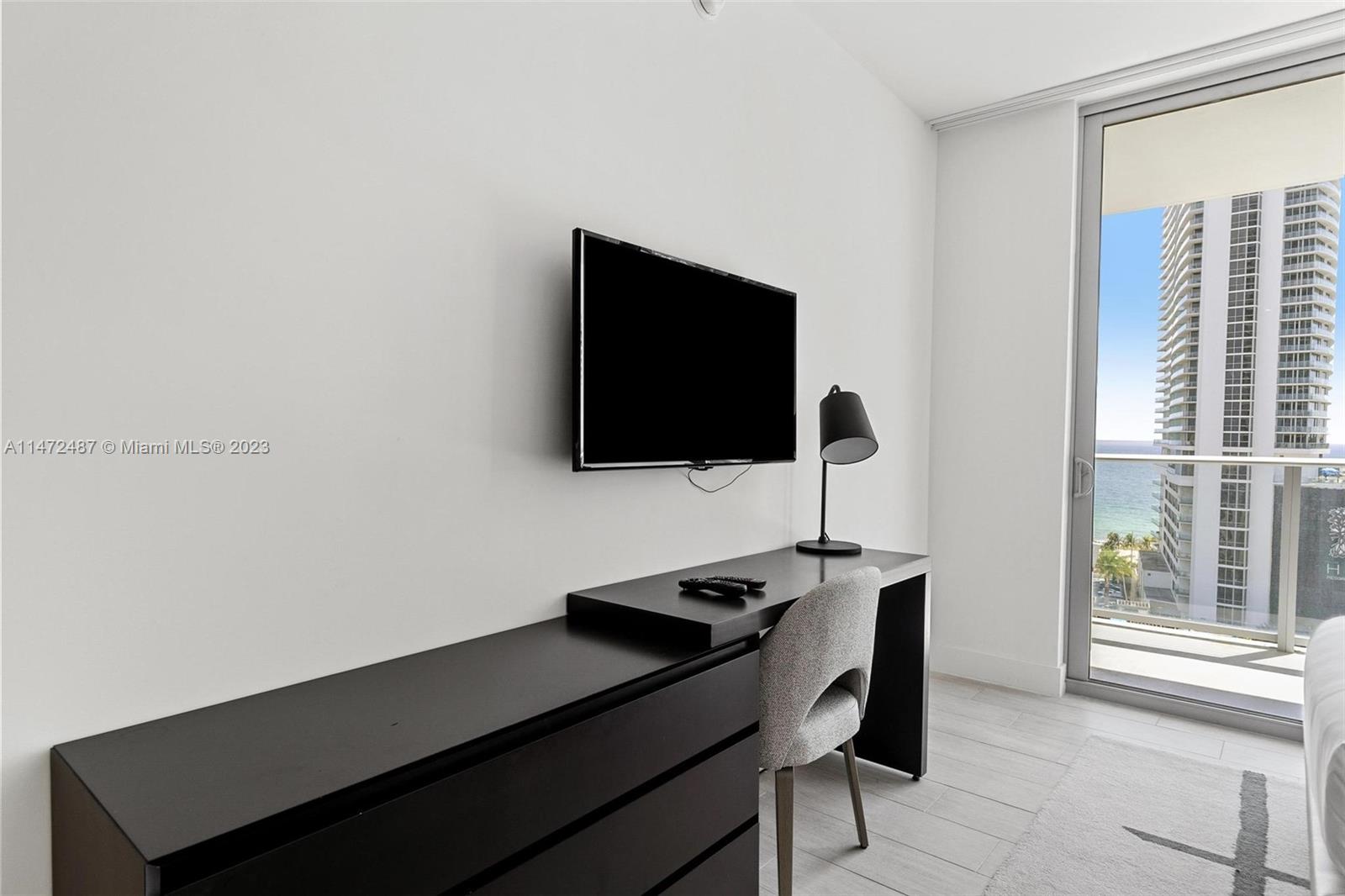 4010 South Ocean Drive, Unit R1107 Hollywood, FL 33019 - Photo 23 of 25 a view of a workspace with furniture and a flat screen tv