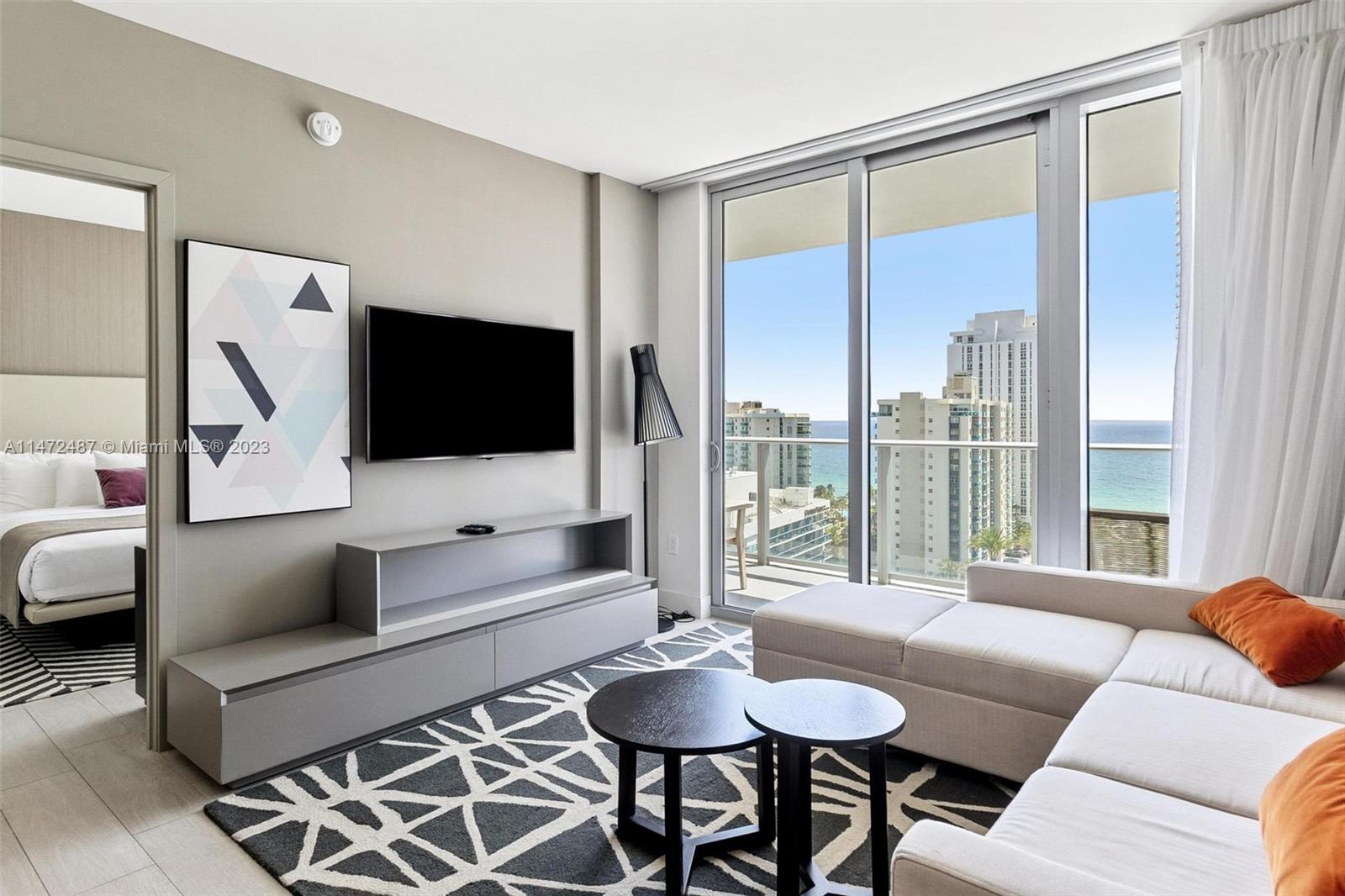 4010 South Ocean Drive, Unit R1107 Hollywood, FL 33019 - Photo 3 of 25 a living room with furniture and a flat screen tv