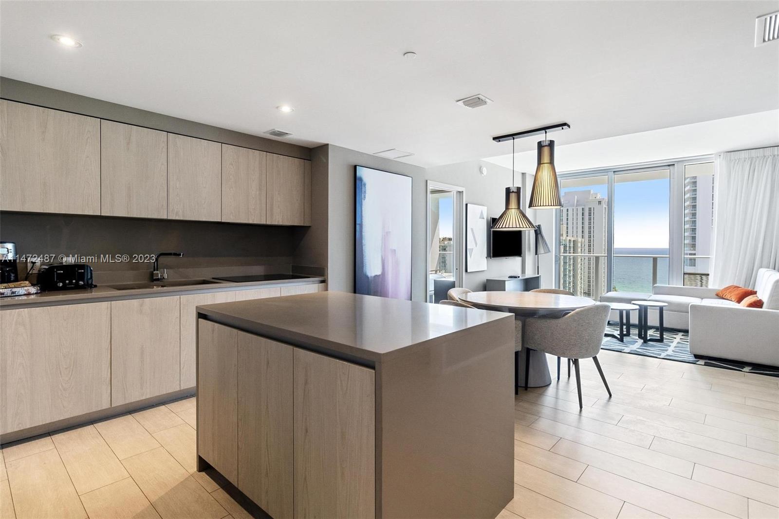 4010 South Ocean Drive, Unit R1107 Hollywood, FL 33019 - Photo 8 of 25 a kitchen with kitchen island granite countertop a sink and counter space