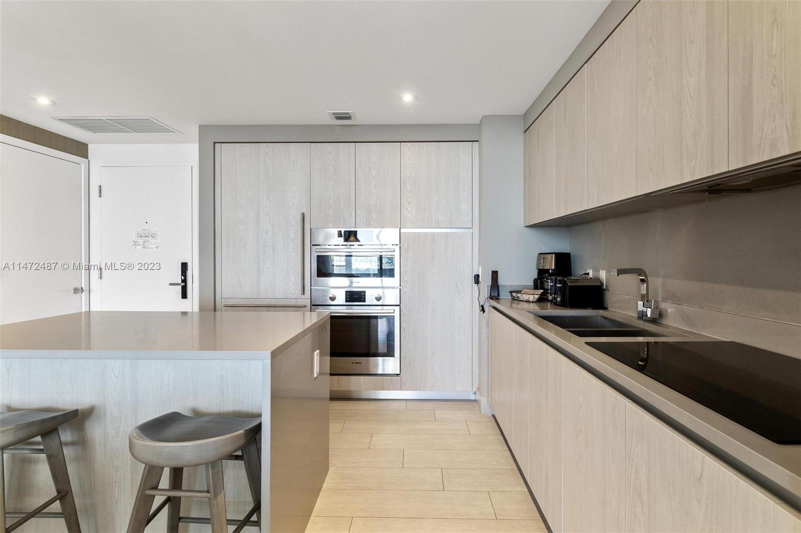 4010 South Ocean Drive, Unit R1107 Hollywood, FL 33019 - Photo 9 of 25 a kitchen with granite countertop a sink a stove and cabinets