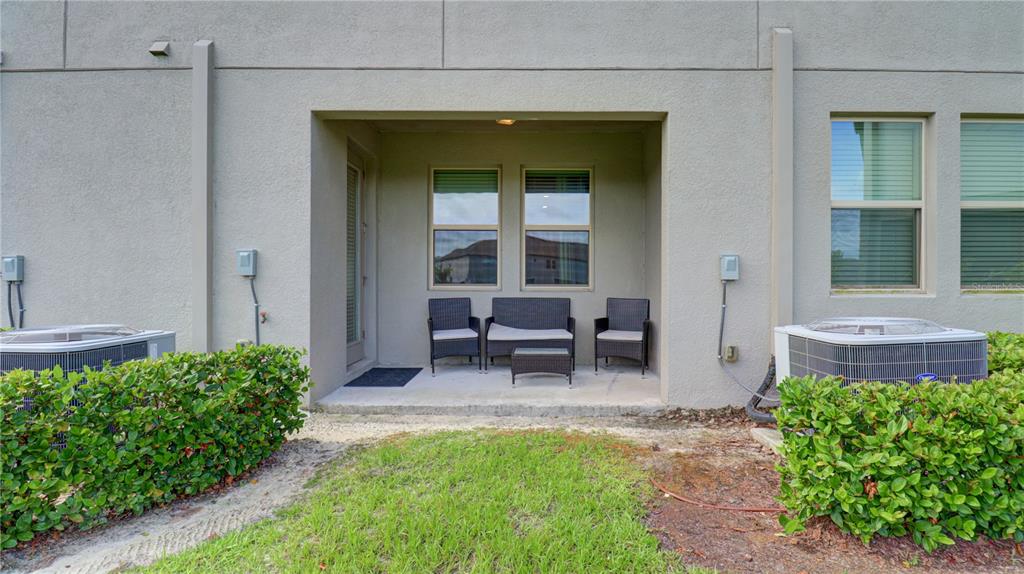 31632 Blue Passing Loop Wesley Chapel, FL 33545 - Photo 48 of 48 a backyard of a house with outdoor seating