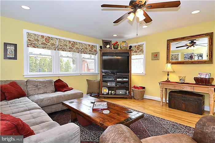 10017 Portland Road Silver Spring, MD 20901 - Photo 11 of 30 a living room with furniture a flat screen tv and a large window