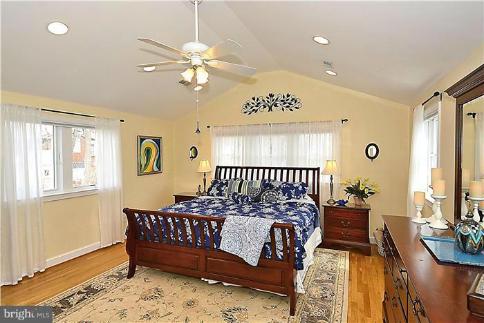 10017 Portland Road Silver Spring, MD 20901 - Photo 16 of 30 a bedroom with a bed and a chandelier